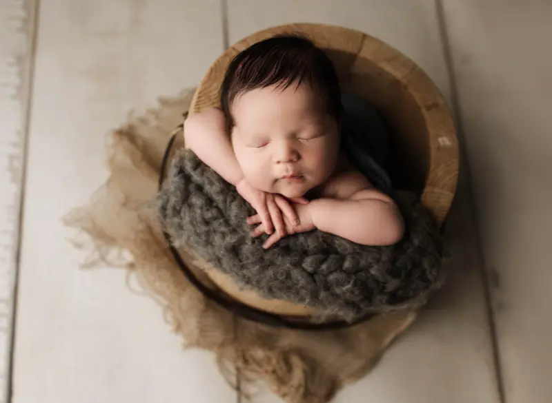 Supported newborn posing practice for composite photography safety