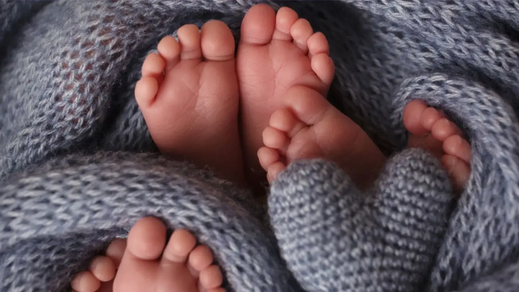 Tiny newborn feet wrapped in a soft gray knit layer - newborn photography prop - Dvotinst