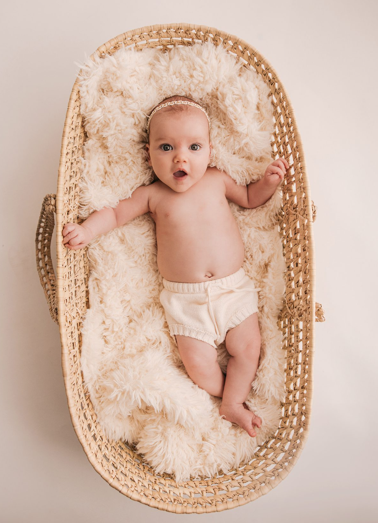 Newborn resting in a soft basket setup for a first-weeks baby photoshoot - newborn photography prop - Dvotinst