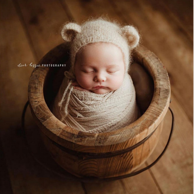 Handmade mohair bonnet prepared on a clean accessory station for newborn headshot sessions - Dvotinst